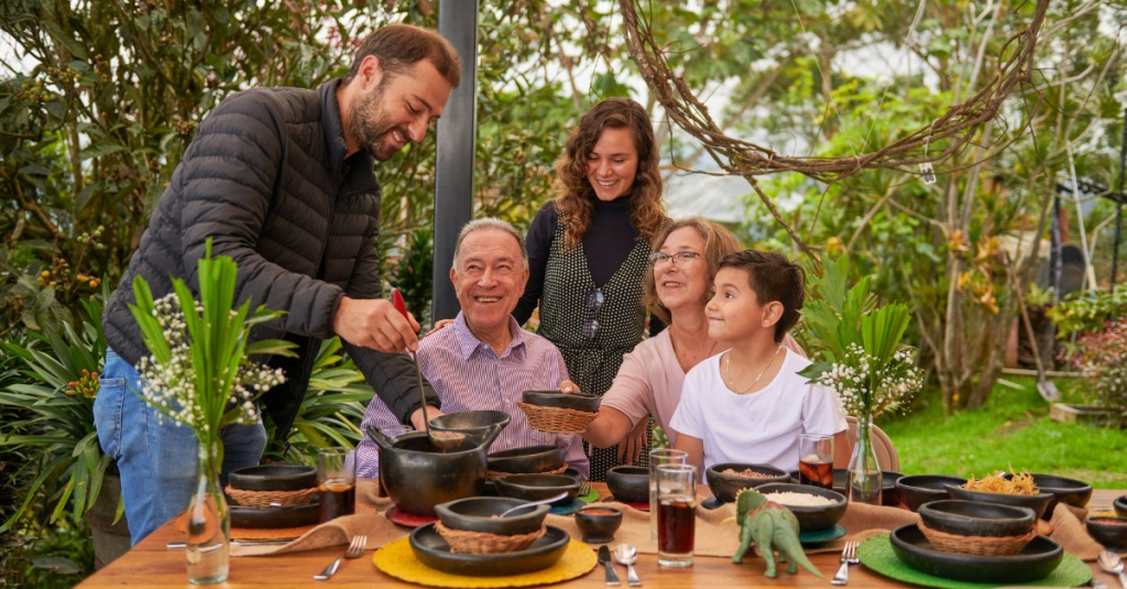 Multigenerational family enjoying lunch together in a backyard setting