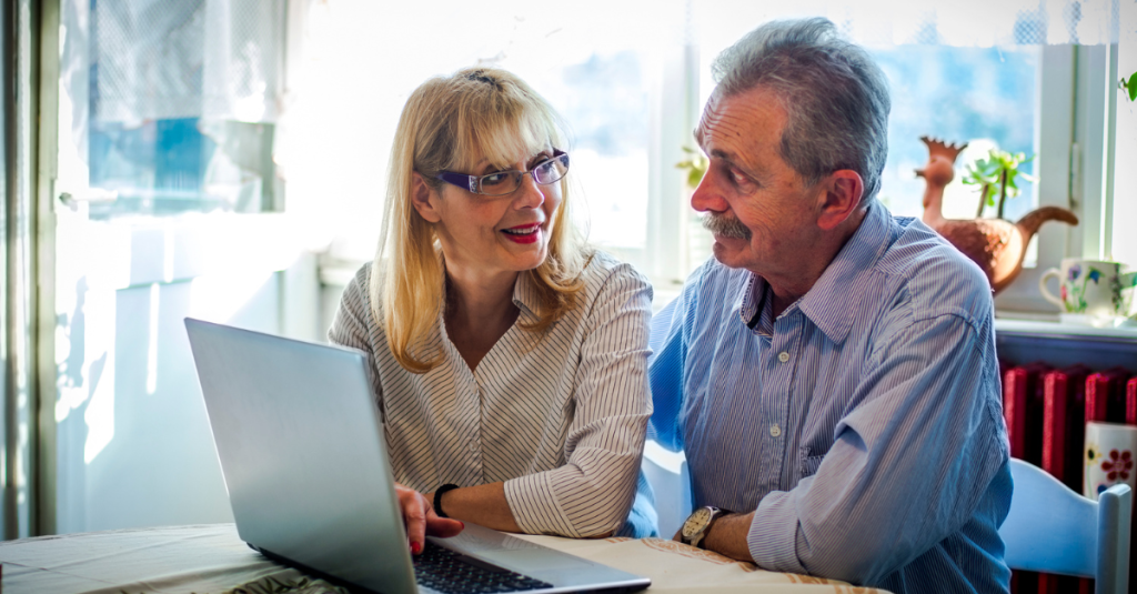 Couple reviewing first-floor master suite options online