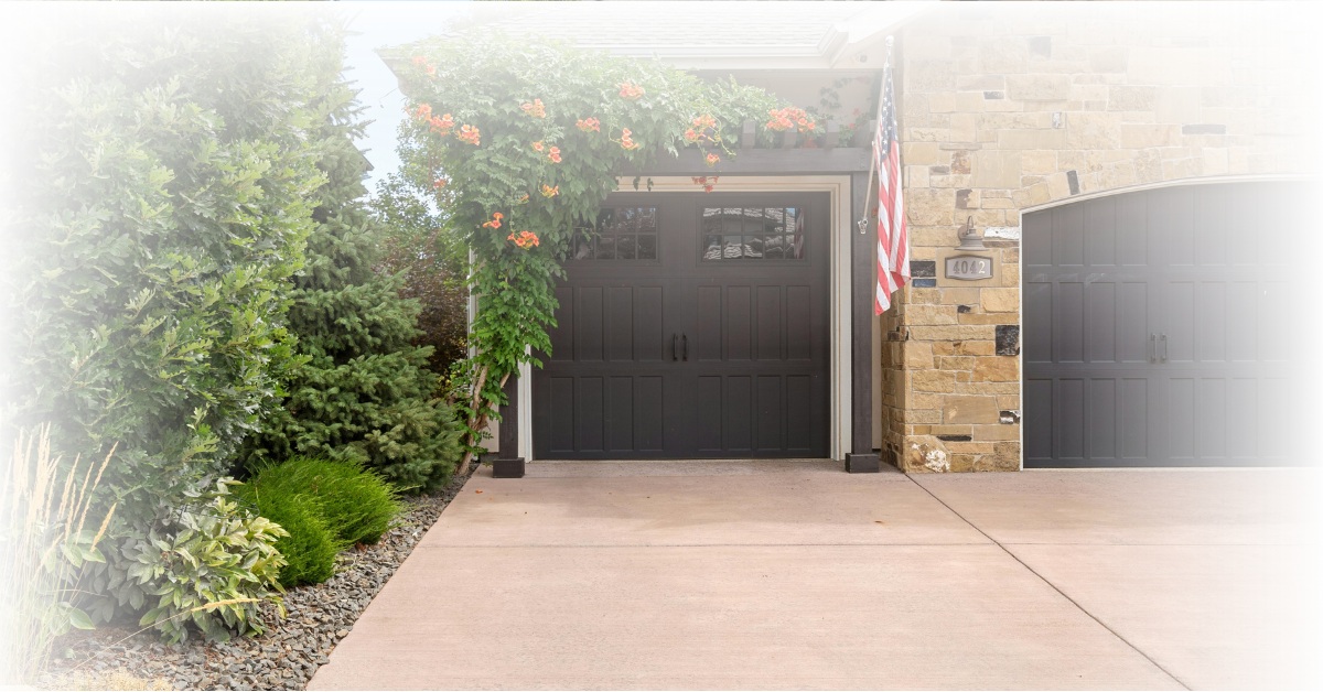 Front view of a modern garage addition with brick and siding exterior