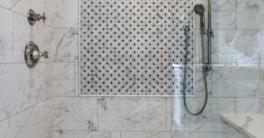 Curbless shower featuring wall niche and bench seating for safety.