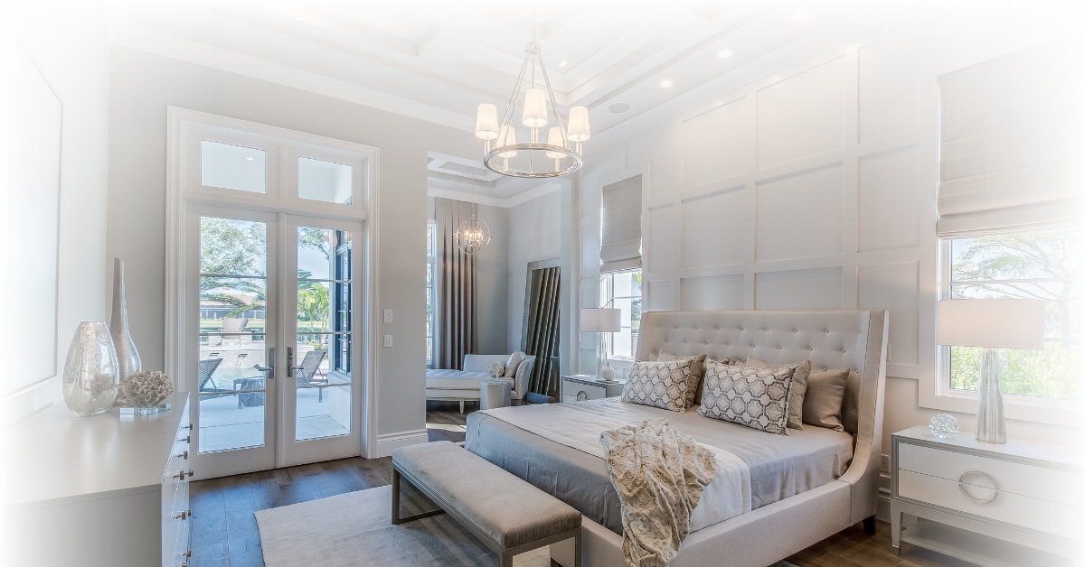 Elegant master suite with chandelier and natural light