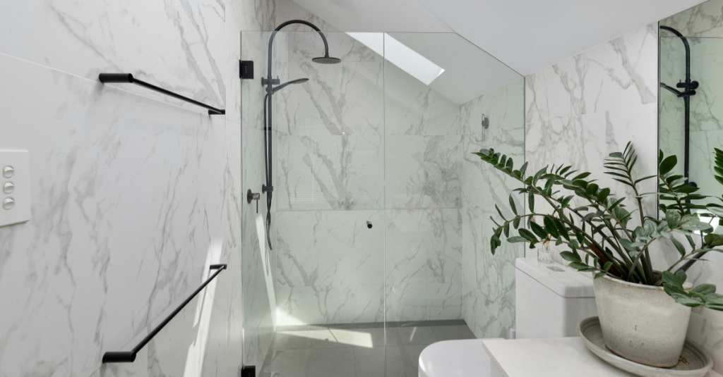Curbless shower with matte black fixtures and accessible layout.