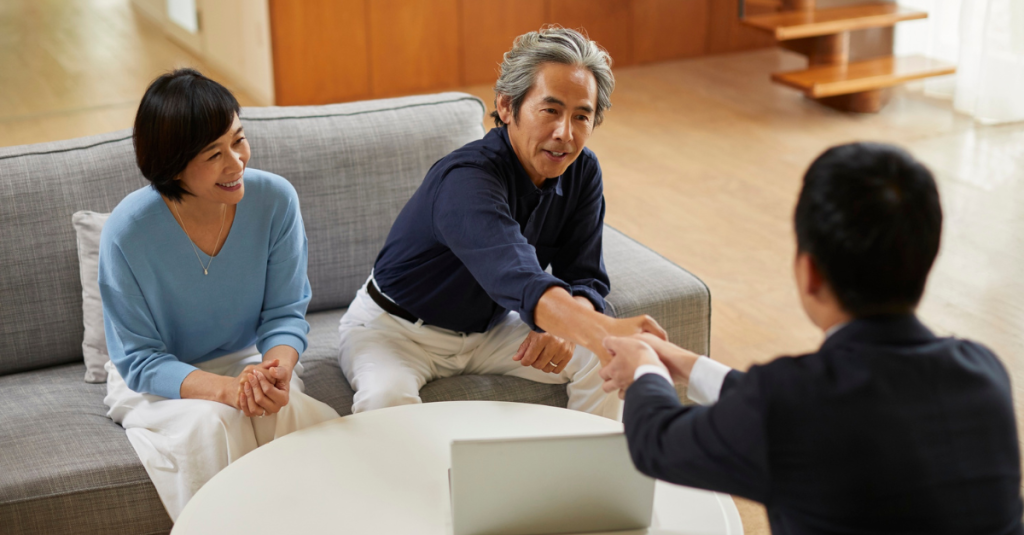 Certified aging-in-place specialist consulting with older homeowners in living room